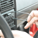 mechanic using fastener remover tool to replace car radio stereo